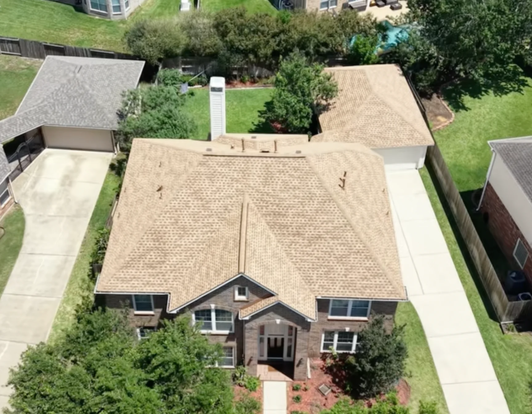 Aerial front view of a light brown shingle roof.