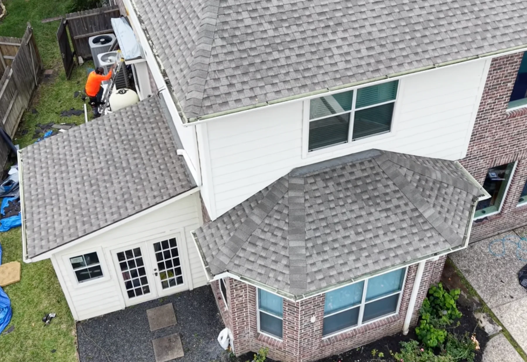 Aerial view of a gray shingle roof across multiple roof levels.